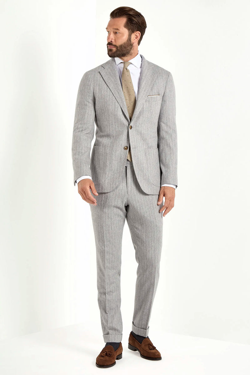 Light grey striped suit, Italian style, made in Italy, tailored luxury suit, elegant menswear suit, refined formalwear, premium Italian craftsmanship, classic striped suit, sophisticated business suit, smart formal attire, versatile modern suit, polished two-piece suit, fine Italian tailoring, upscale menswear suit, timeless Italian suit, refined professional look, sharp tailored suit, luxury office suit, contemporary striped blazer, Italian elegance suit