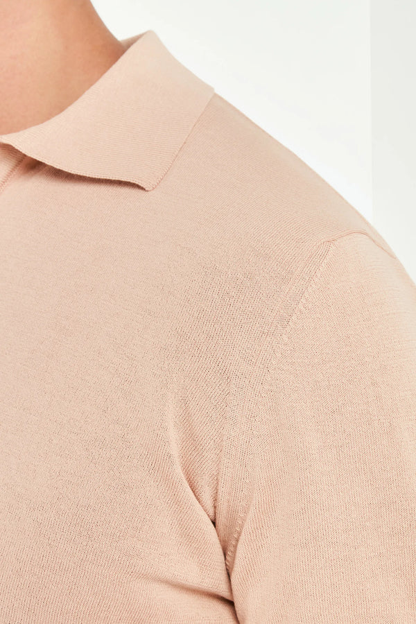 Close-up of a beige sweater with a collar on a white background
