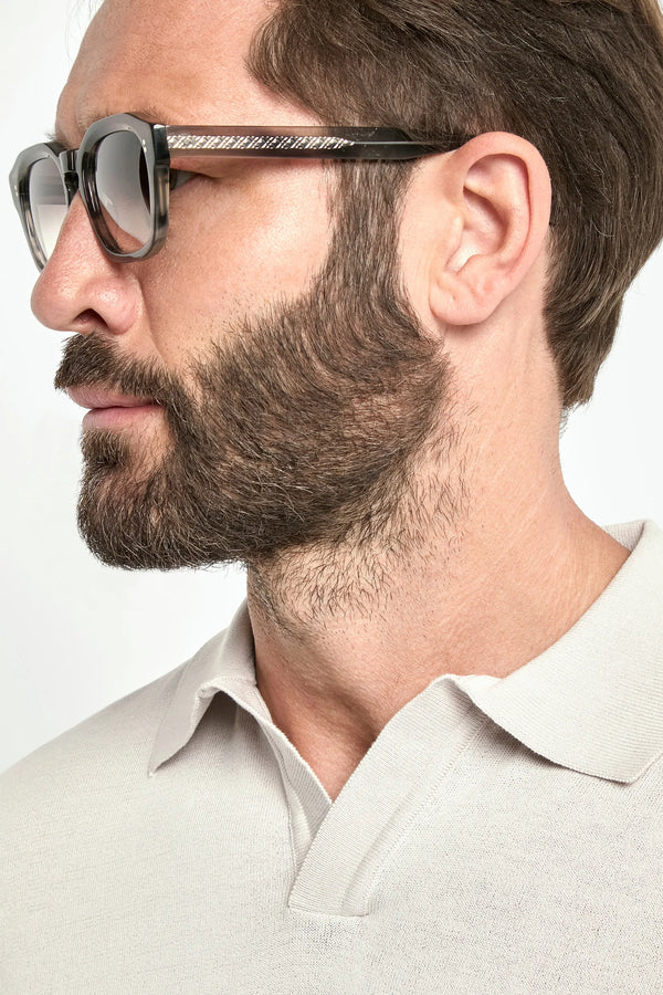 Man wearing glasses with a neutral background