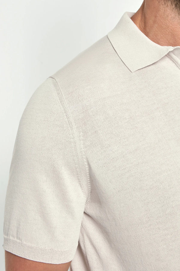 Close-up of a beige polo shirt on a white background
