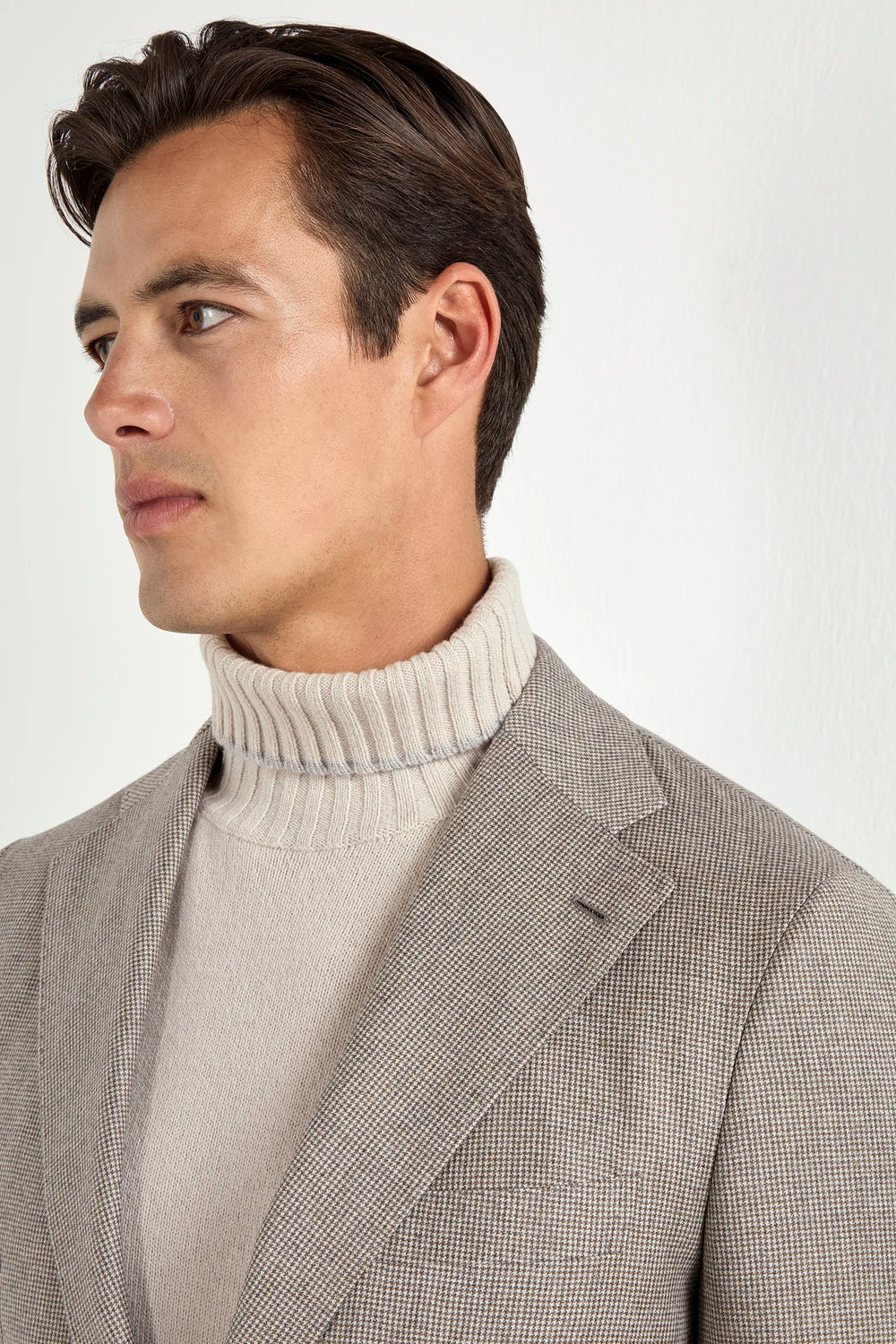Taupe houndstooth suit, Italian style, made in Italy, tailored luxury suit, elegant menswear suit, refined formalwear, premium Italian craftsmanship, classic houndstooth weave suit, sophisticated business suit, smart formal attire, versatile modern suit, polished two-piece suit, fine Italian tailoring, upscale menswear suit, timeless Italian suit, refined professional look, sharp tailored suit, luxury office suit, contemporary houndstooth blazer, Italian elegance suit